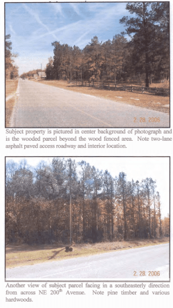 Subject property is pictured in center background of photograph and