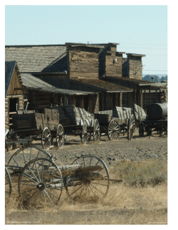 Old wagons and buildings in Cody